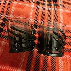 Source Unknown Black Glass Candle Holders with Skeleton Hand Accent